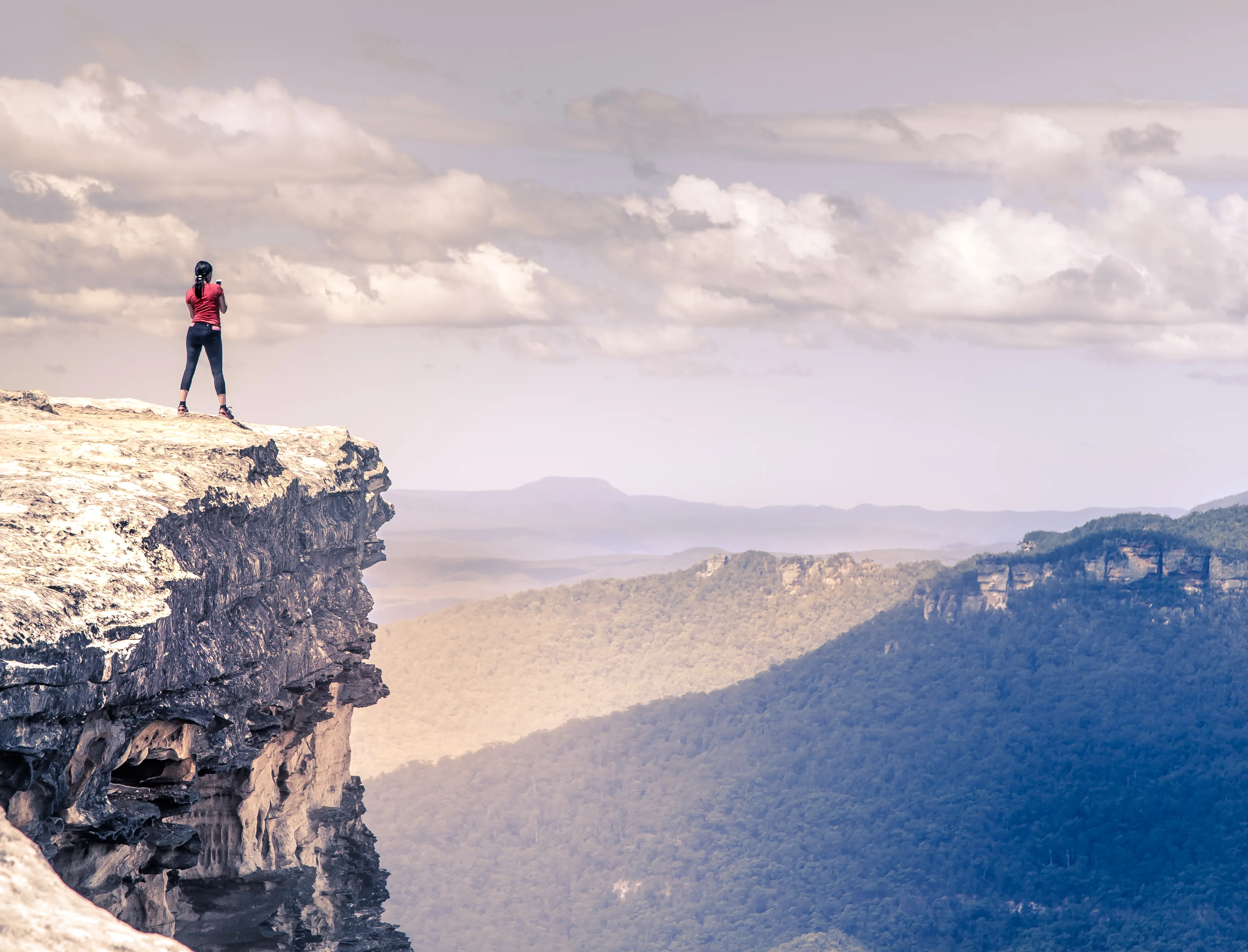 Woman standing in front of a cliff